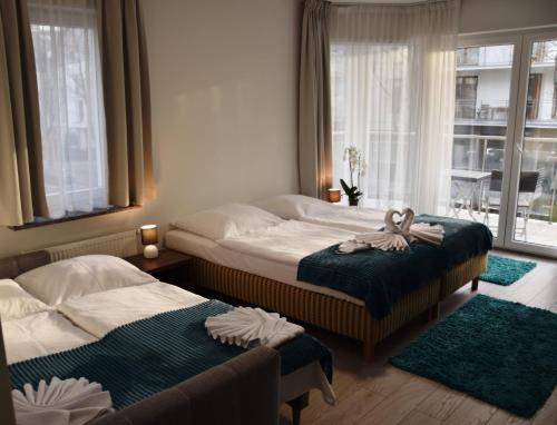 En eller flere senge i et værelse på Aparthotel Baltic Spa