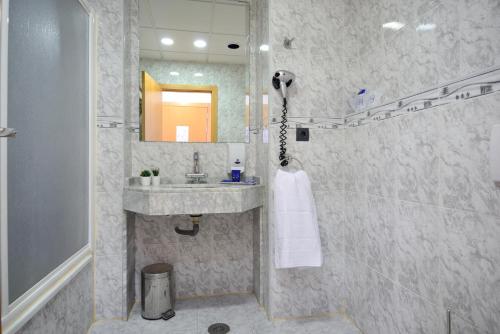 a bathroom with a sink and a shower at Hotel Miramar Playa in Playa de Miramar