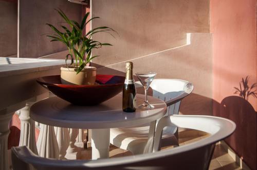 a table with a bottle of champagne and a plant at Zante Nest Studios & Apartments in Alikanas