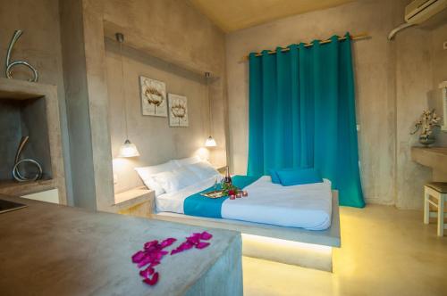 a bedroom with a large bed with a blue curtain at Zante Nest Studios & Apartments in Alikanas