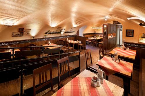 a dining room with tables and chairs in a restaurant at Altstadt-Hotel Zum Hechten in Füssen