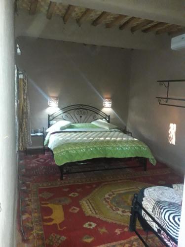 A bed or beds in a room at Riad Tagmadarte Ferme d'Hôte