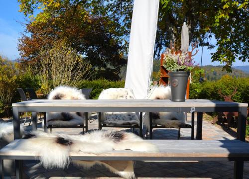 a group of dogs laying around a picnic table at Genusshotel Hirschen - Erholung im Grünen (Südschwarzwald) in Sallneck
