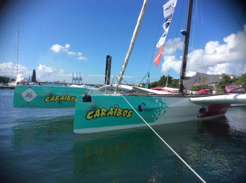 a sailboat is tied up in the water at Les Manguiers in Deshaies
