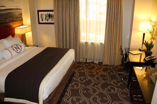 a hotel room with a bed and a window at Northern Hotel in Billings