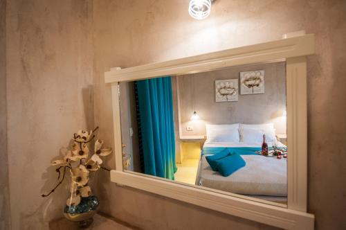 a reflection of a bedroom with a bed in a mirror at Zante Nest Studios & Apartments in Alikanas