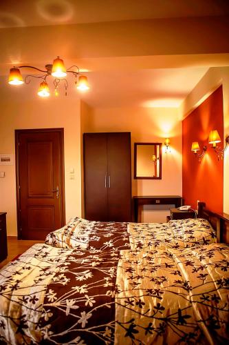 a bedroom with a large bed in a room at Andromeda Hotel Limni Plastira in Koutsodímos