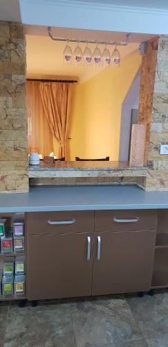 a kitchen with a counter top and a large mirror at Casa Alina in Arpaşu de Sus