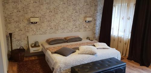 a bedroom with a bed with pillows on it at Casa Alina in Arpaşu de Sus