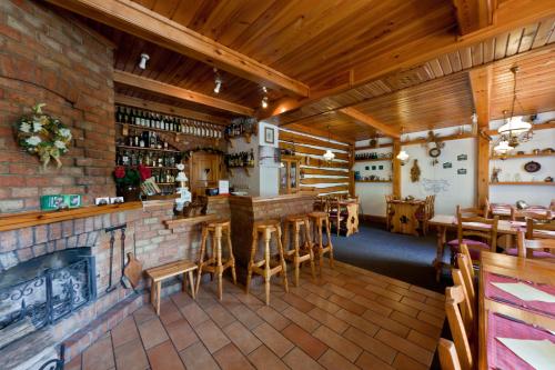 a bar in a restaurant with a brick wall at Penzion Linhart in Poděbrady