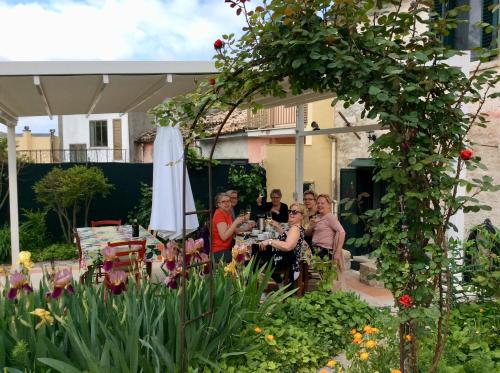 a group of people sitting at a table in a garden at Art & Breakfast in Ripabottoni