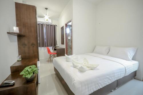 a bedroom with a bed with white flowers on it at Hotel Wualai by CMStay in Chiang Mai