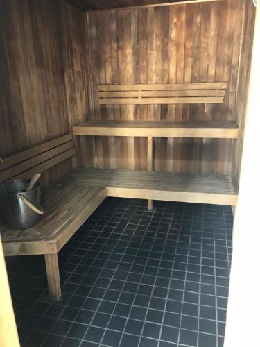 a wooden bench sitting on a tiled floor in a sauna at Felix 374 FF Apartment in Brisbane
