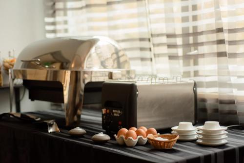 a kitchen counter with eggs in front of a machine at Cit'Hotel Criden in Tours