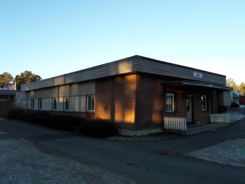 a small brick building with the sun shining on it at Östersunds Camping in Östersund