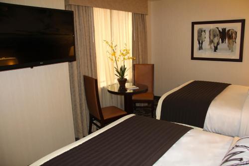 a hotel room with two beds and a table at Northern Hotel in Billings