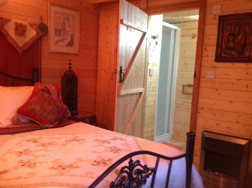 a bedroom with a bed in a room with a fireplace at Alice Guest house in Cheltenham