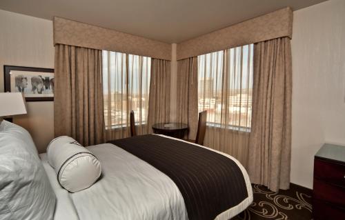 a hotel room with a bed and a large window at Northern Hotel in Billings