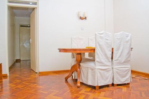 a table and two chairs sitting at a table at Njema Court Apartment in Nairobi