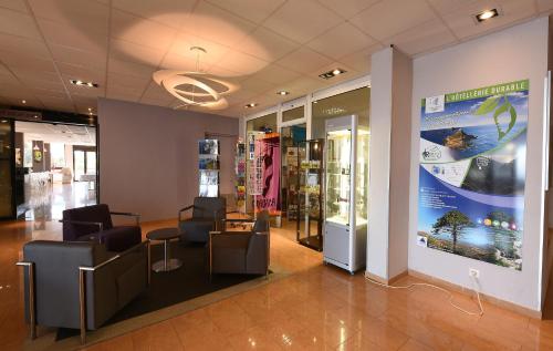 a waiting room with chairs and a sign in a store at Résidence Les Calanques in Ajaccio