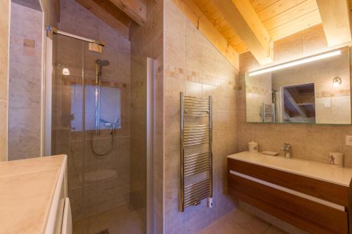 a bathroom with a shower and a sink and a toilet at Chalet Asphodel in Plan Fey