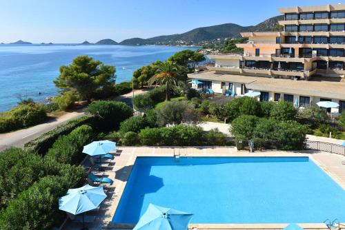 an aerial view of a resort with a swimming pool and the ocean at Résidence Les Calanques in Ajaccio