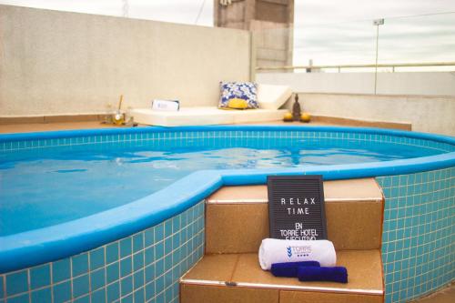 a swimming pool with two boxes of towels in it at Torre Hotel Ejecutivo in Santa Cruz de la Sierra