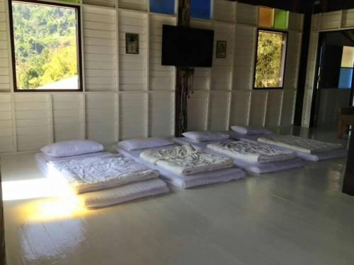 four mattresses lined up on the floor in a room at Khaokor Remind by Palek in Khao Kho