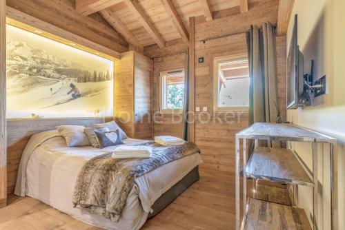 a bedroom in a log cabin with a bed at Chalet Annelya in Combloux