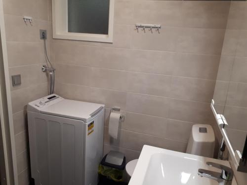 a small bathroom with a toilet and a sink at Vuokatti Slope Suite in Vuokatti