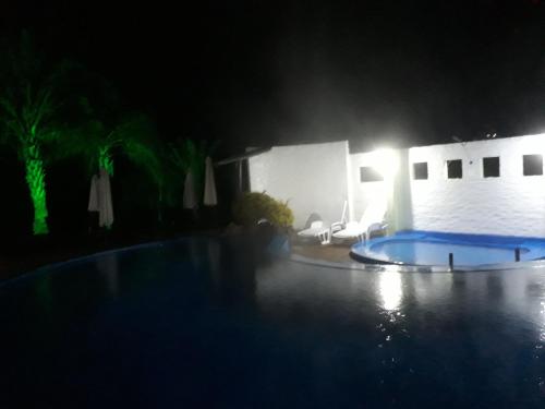 a night time picture of a swimming pool at Hotel La Posta del Dayman in Termas del Daymán