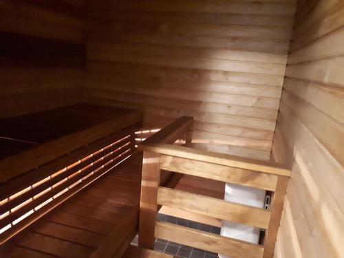 an empty sauna with a bench in the middle at Vuokatti Slope Suite in Vuokatti