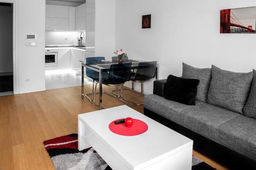 a living room with a couch and a table at Flexible SelfCheckIns 7 - Zagreb - Garage - Electric vehicle ccharger - Loggia - New - Luxury - Apartments Repinc 7 in Zagreb
