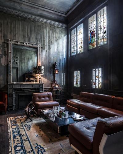 a living room with leather furniture and a fireplace at Hotel Les Bains Paris in Paris