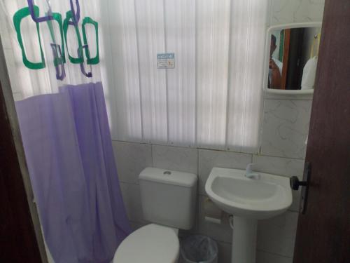 a small bathroom with a toilet and a sink at Pousada Bom Jesus in Tamandaré