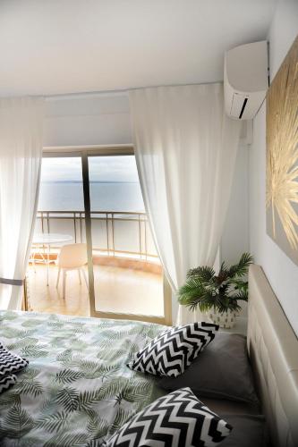 a bedroom with a bed and a view of the ocean at Sunset in Santa Pola