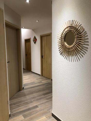 a hallway with a large mirror on the wall at La Datcha du Parc in Husseren-Wesserling