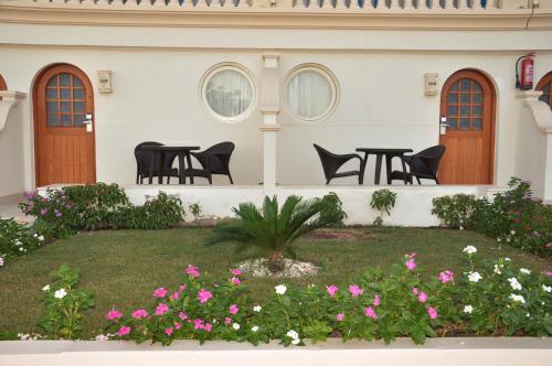 a patio with tables and chairs and flowers at Marina Sharm Hotel in Sharm El Sheikh