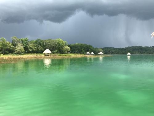 a large body of water with tents in the background at Hotel Mon Ami in El Remate