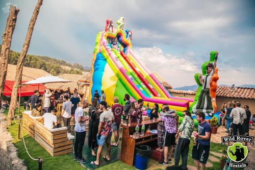 a crowd of people standing in front of a inflatable slide at Wild Rover Cusco in Cusco