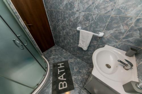 a bathroom with a toilet and a sink and a shower at Apartments Vukman in Trogir