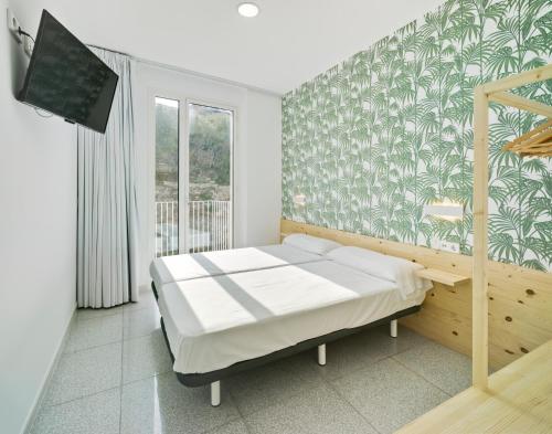 a bedroom with a bed and a tv in it at Loop INN Hostel Cartagena in Cartagena