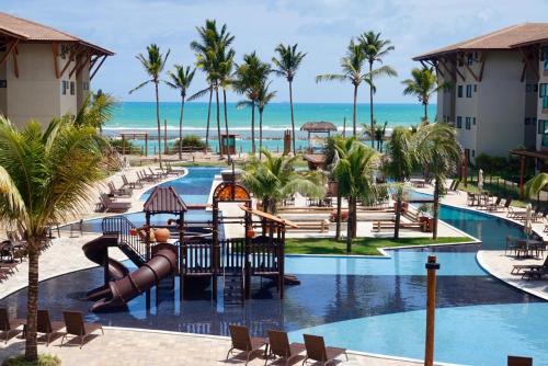 a view of the pool at a resort with a slide at Samoa Beach Resort in Porto De Galinhas