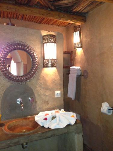 a bathroom with a sink and a mirror at Riad Mehdia in Marrakech