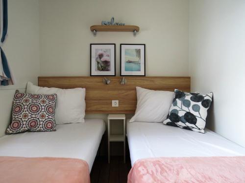 two beds sitting next to each other in a room at Kamp Dole - Navores in Živogošće