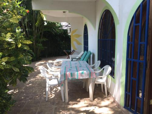 a blue table and chairs on a patio at La Perlita in Jacó