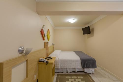 Postel nebo postele na pokoji v ubytování Tri Hotel Executive Criciúma