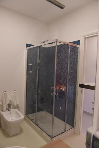 a bathroom with a shower with a toilet and a sink at Palazzo Galifi in Paterno