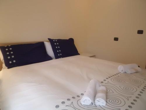 a white bed with towels on top of it at Affittacamere Ca' Fattorini in Baceno