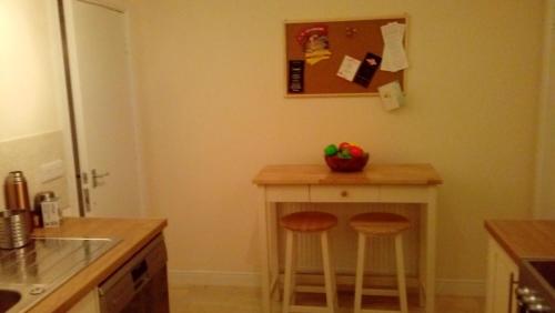 a kitchen with a small table with two stools at Heart of Filey in Filey